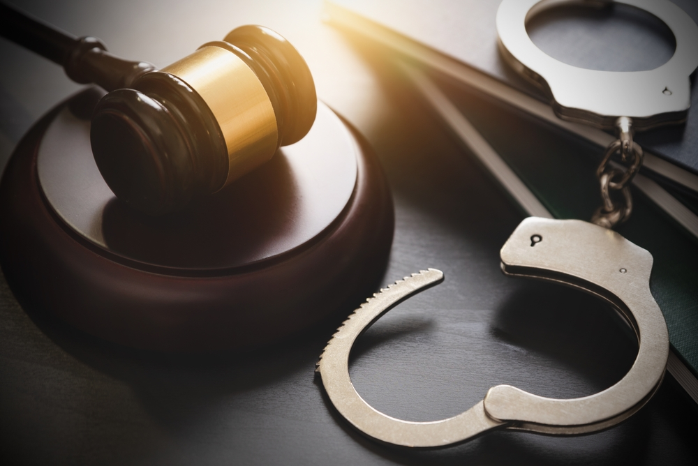 A criminal defense lawyer practicing criminal law working on criminal defense cases in a law office in Portage MI offering a free consultation for defense of crime accusations for the judge in the courtroom