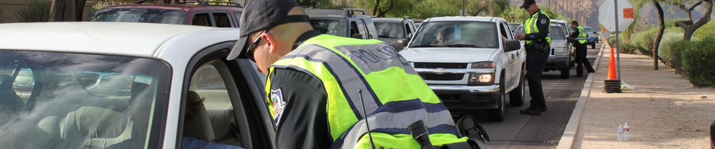 A police officer conducting a roadside drug test on a driver suspected of OUID in Michigan.