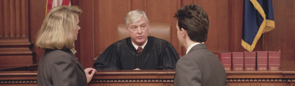 A courtroom scene with a judge presiding over a felonious assault case in Michigan.